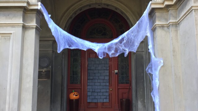 Cobwebs and jack-o-lanterns at the entrance.